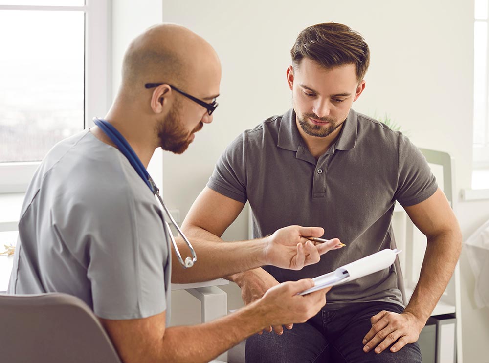 Doctor talks to his patient after a medical examination at the clinic