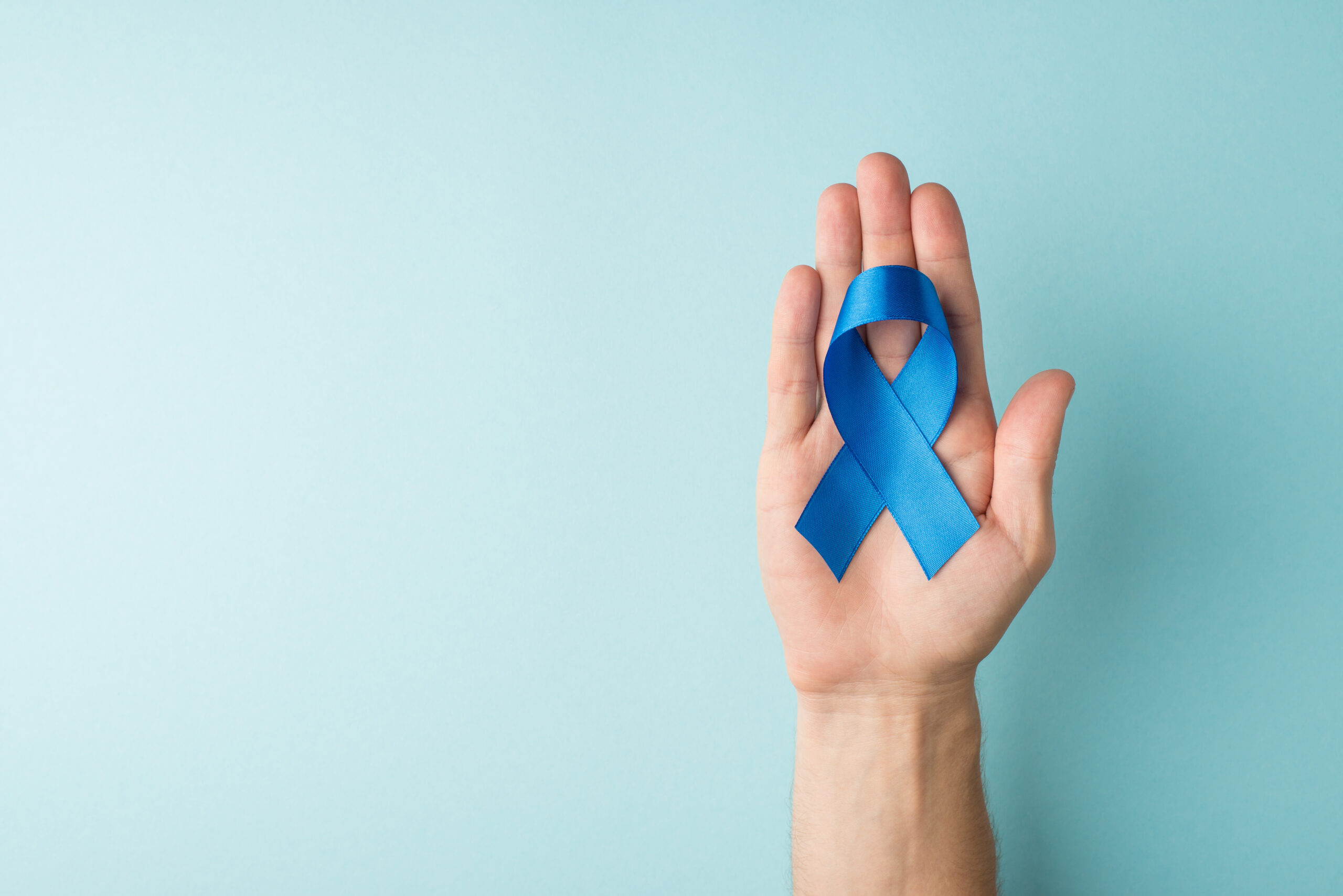 a blue ribbon placed in palm